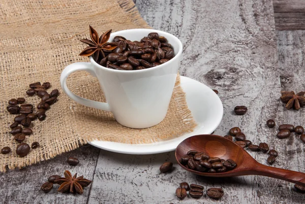 Cup with coffee beans — Stock Photo, Image