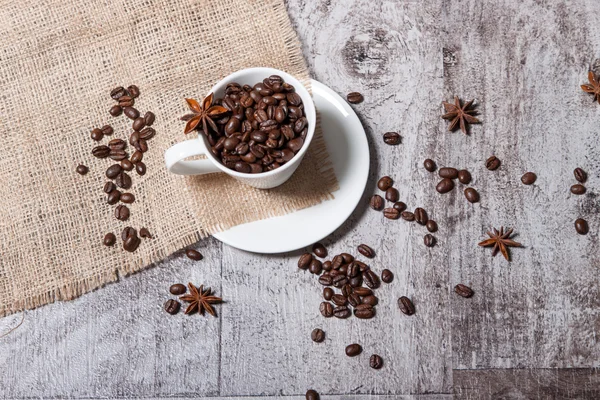 Cup with coffee beans — Stock Photo, Image