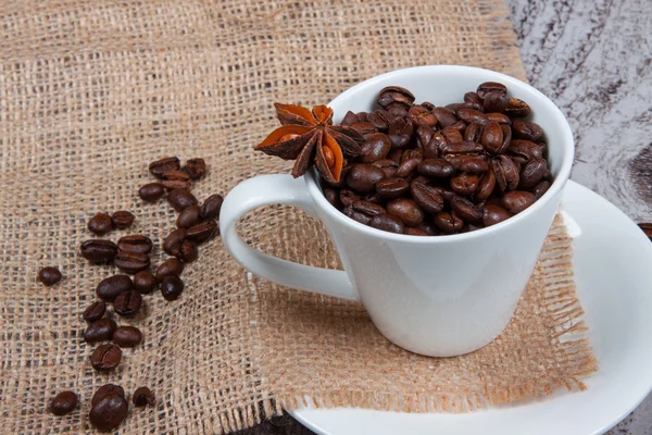 Cup with coffee beans — Stock Photo, Image