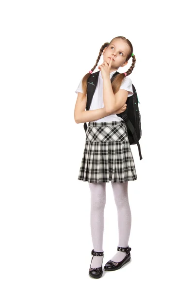 Chica en uniforme escolar con libros mirando hacia arriba —  Fotos de Stock