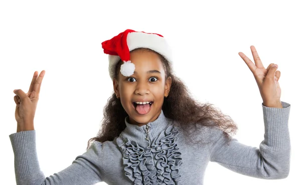 Cheerful dark-skinned girl in a red scarf and hat of Santa Claus. Winter portrait of joyful adolescent girls — Stock Photo, Image