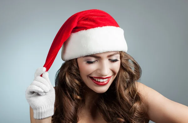 Beautiful young woman in a Santa Claus hat. — Stock Photo, Image