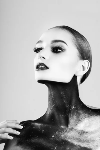 A woman with black and white makeup holding her hands to her face photo –  Halloween makeup Image on Unsplash