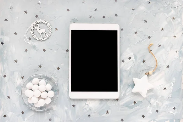 Digital tablet on winter holidays blue background
