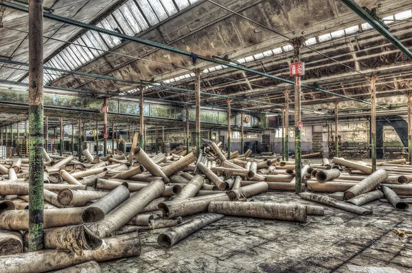 Cardboard rolls in an abandoned warehouse — Stock Photo, Image