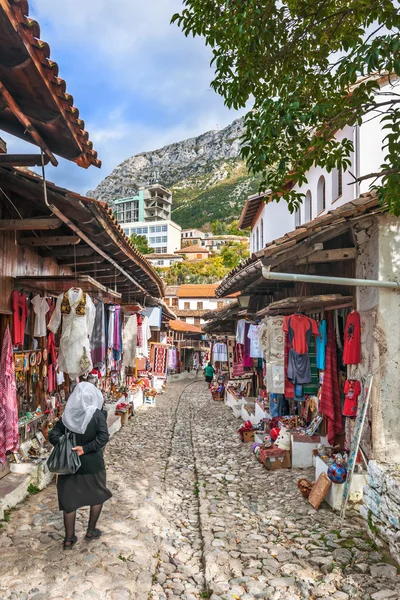 Elderly woman walking along the bazaar ok Kruja