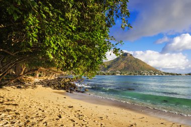 Rocky and sandy shore in Tamarin Bay, Mauritius clipart