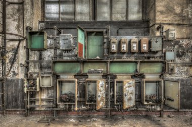 Decayed electrical power cabinets in an abandoned factory clipart