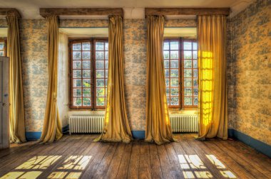 Windows with yellow curtains in an abandoned castle clipart