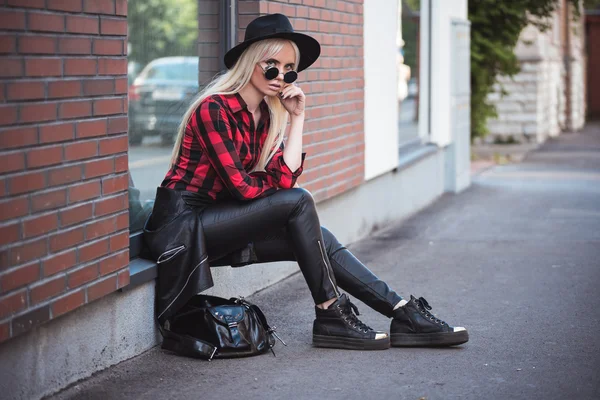 Beautiful blonde young woman in posing outdoors — Stock Photo, Image