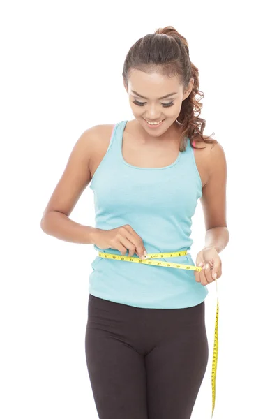 Sporty woman measures waistline — Stock Photo, Image