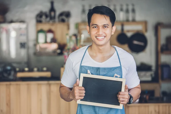 Male cafe owner with blank board — Stock Photo, Image