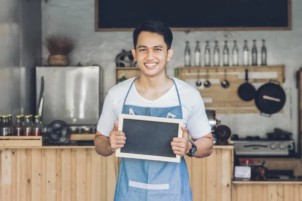 Male cafe owner with blank board — Stock Photo, Image