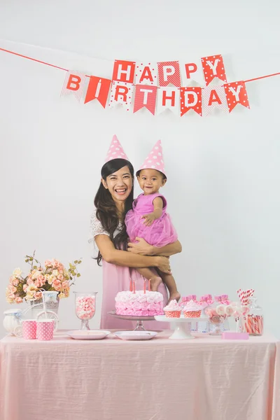 Girl celebrating first birthday with mother — Stock Photo, Image