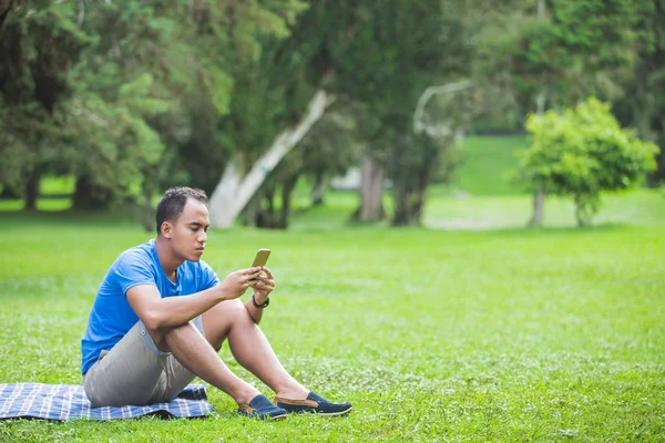Young man texting on the cellphone — Stock Photo, Image