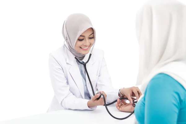 Asiática médico feminino verificando a pressão arterial de um paciente — Fotografia de Stock