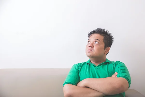 Fat man thinking and looking up to copyspace — Stock Photo, Image