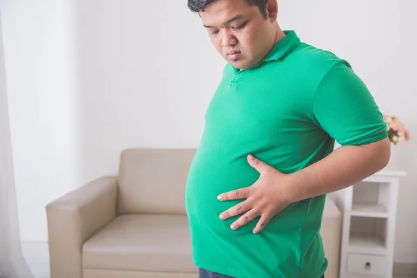 Obeso uomo tenendo la sua grande pancia — Foto Stock