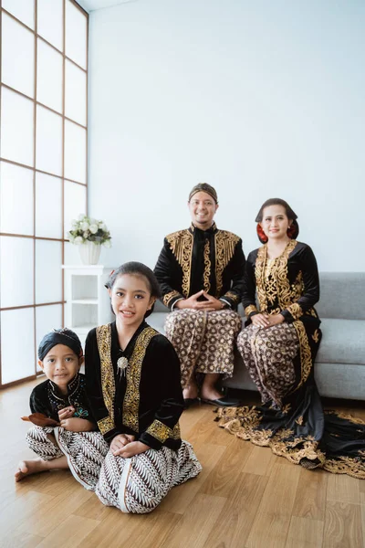 Retrato de uma família feliz vestindo roupas tradicionais javanesas. — Fotografia de Stock