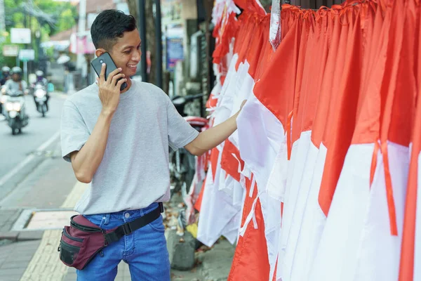 Portrait of a young man selling flags taking orders — Stock Photo, Image