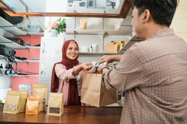 Junge Männer kaufen diese verpackten Produkte bei der Frau — Stockfoto