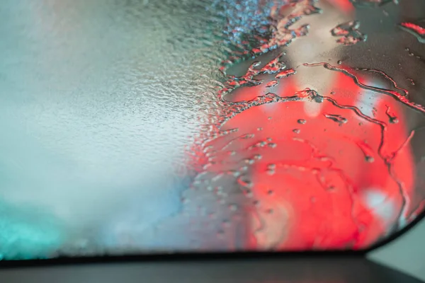image photo of a car cleaner man spraying the windshield