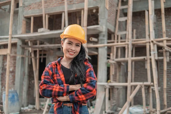 Belle femme asiatique entrepreneurs portant casques de sécurité avec les mains croisées — Photo