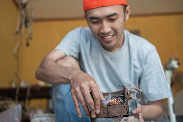 Männlicher Elektronikarbeiter installiert neue Spulen, während er Wasserpumpen repariert — Stockfoto