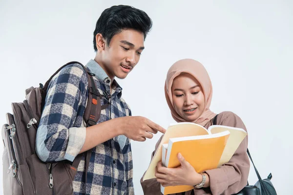 Close up of beautiful muslim women explaining project on book to his partner — Stock Photo, Image