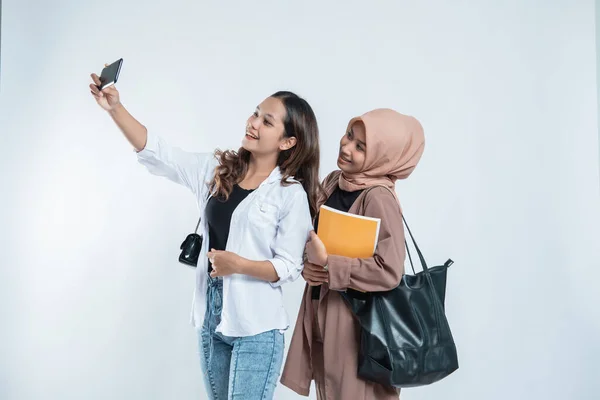 Portret van gelukkige universitaire jeugd die een tas draagt en een selfie maakt met de mobiele telefoon — Stockfoto