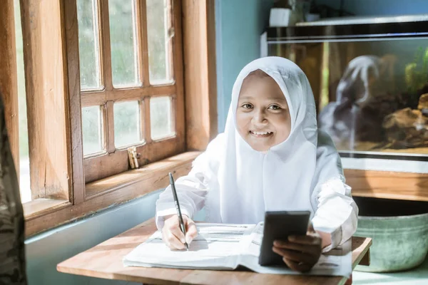 Anak sekolah indonesia belajar pekerjaan rumah selama pelajaran online nya — Stok Foto
