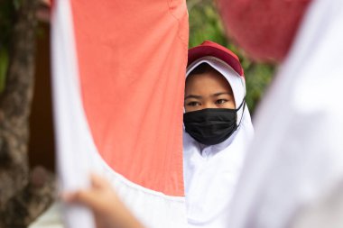 Raising Indonesian Flag by Indonesian elementary student in Pandemic situation