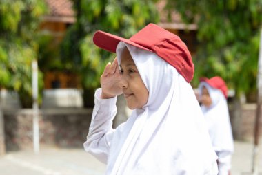 Flag honor is performed by student little girl