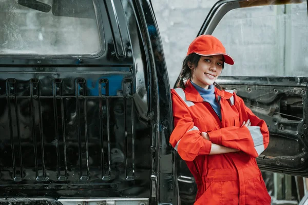 Porträtt av en ung kvinna som arbetar som bilmekaniker — Stockfoto