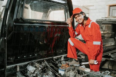portrait of a happy mechanic with the car