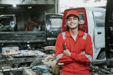 portrait of mechanic carry tools in his hand