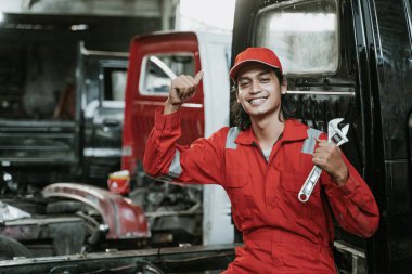 portrait of mechanic carry tools in his hand