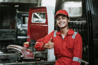 portrait of a young man working as an auto mechanic