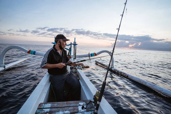 Portrait of a young fisherman fishing on a boat — Stock Photo, Image