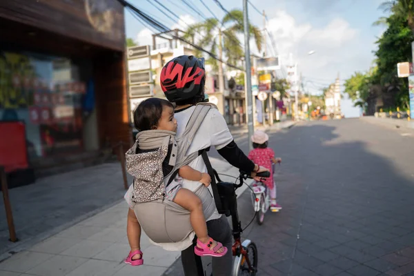 Portrét matky na kole při nošení svého dítěte — Stock fotografie