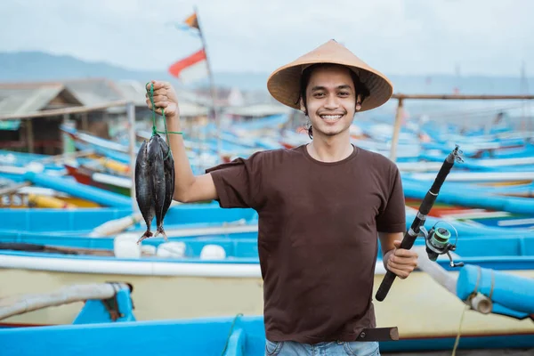 Happy young fisherman on the beach — Stock Photo, Image