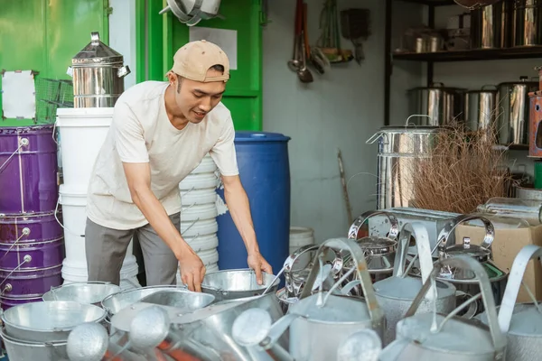 Ásia masculino segurar um balde enquanto organizando o muitos baldes — Fotografia de Stock