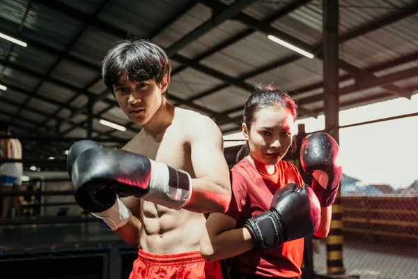 Les boxeurs asiatiques féminins et masculins se tiennent dans des gants de boxe avec dos à dos — Photo