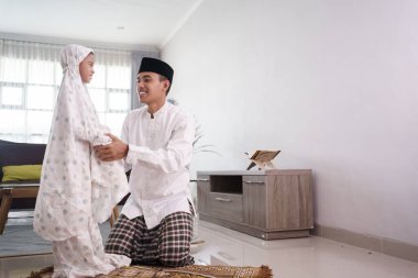 Müslüman baba kızına evde nasıl dua edileceğini öğretiyor.