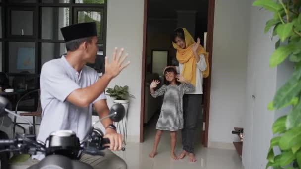 Homem muçulmano indo de moto scooter deixando sua família para trás em casa — Vídeo de Stock