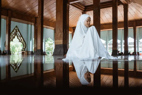 Asian Muslim girls kneel down worship and prays for Allah