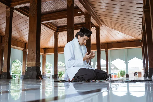 Muslim man kneel down worship and prays for Allah in