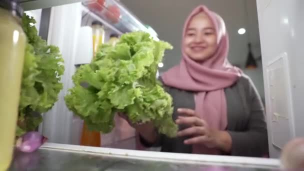 Muslimin öffnet Kühlschranktür und bereitet sich auf Abendessen vor — Stockvideo