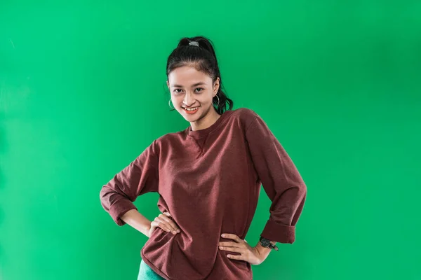 Young Asian woman with hands at her hips while expression smiling off the face — Stock Photo, Image
