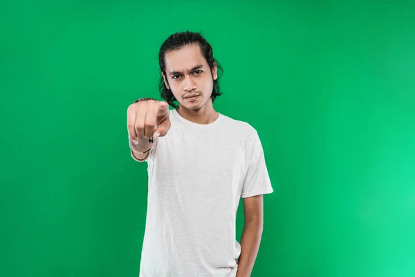 Portrait of a Asian man with a serious expression while pointing hand to the camera — Stock Photo, Image